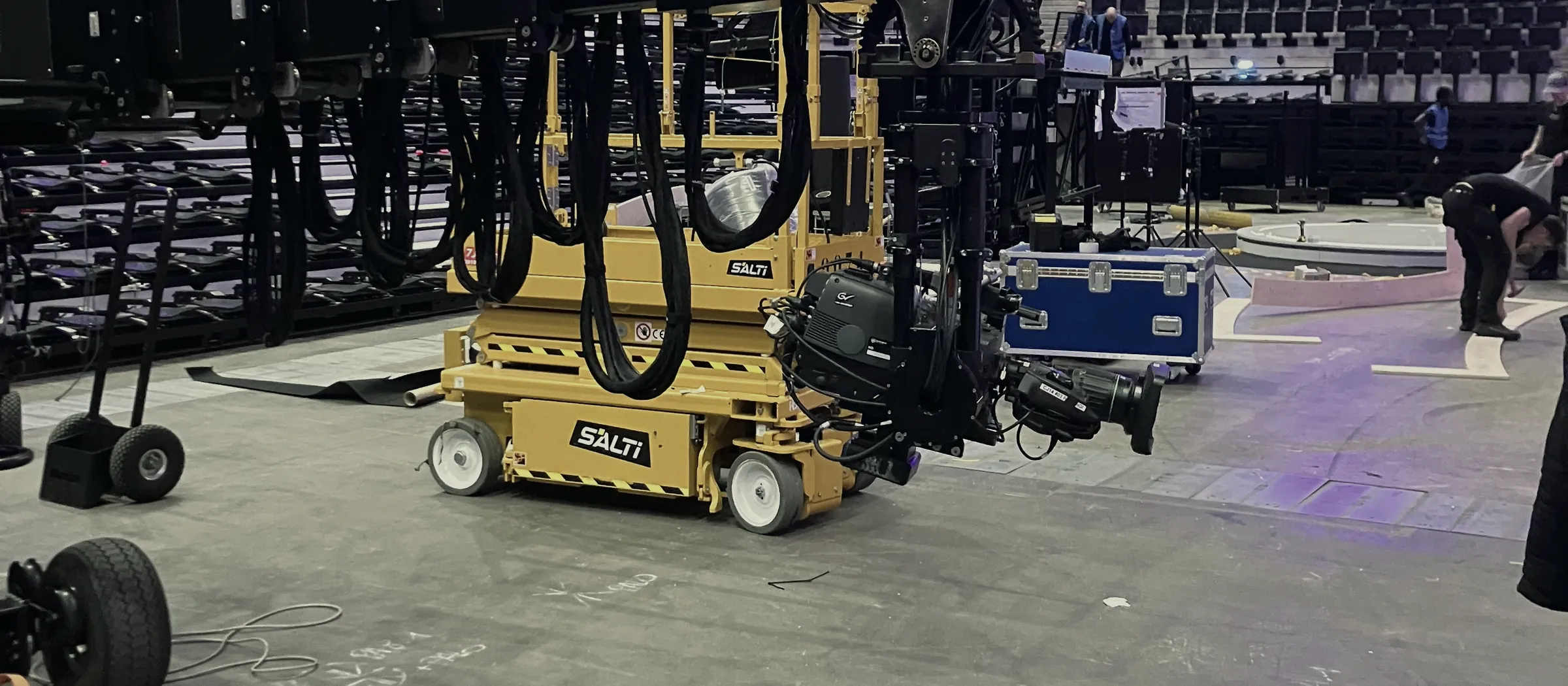 Arena build before doors open: cherry picker, cameras and flight cases